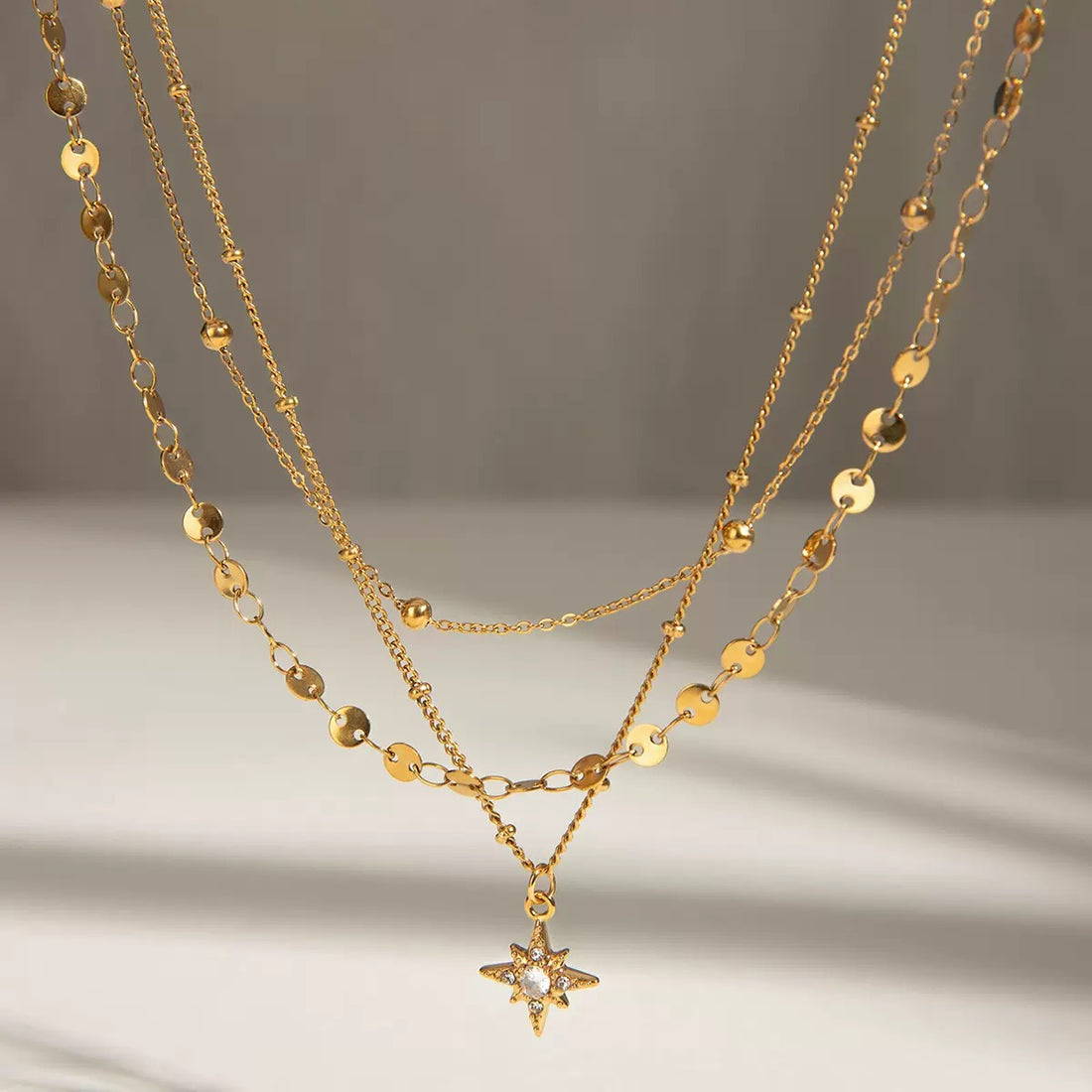 18K Gold-Plated Stainless Steel Three-Layer Necklace with Rhinestone Four-Point Star Pendant, Minimalist Luxury Titanium Steel          询问 ChatGPT